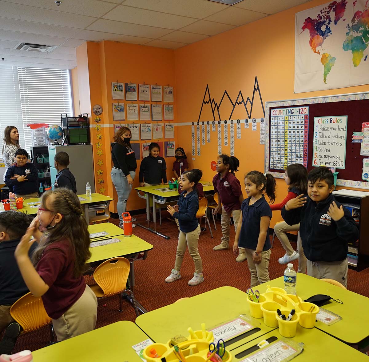 HSA Southwest Teacher and student interacting at a classroom desk