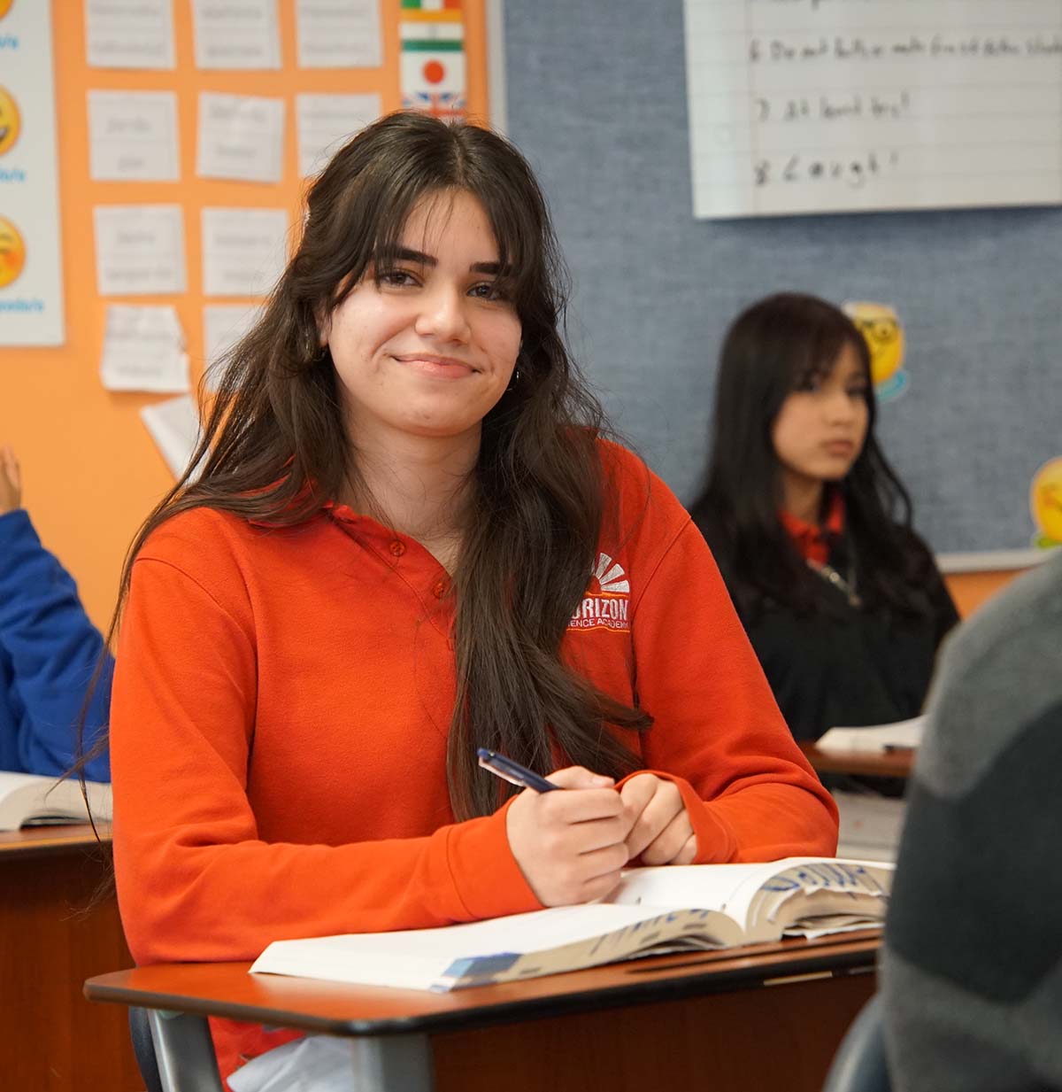 Student drawing in a classroom.